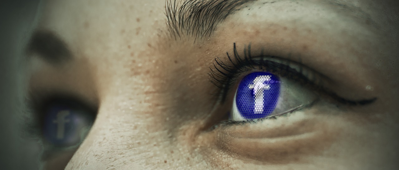 Close up of eye with Facebook logo covering the iris