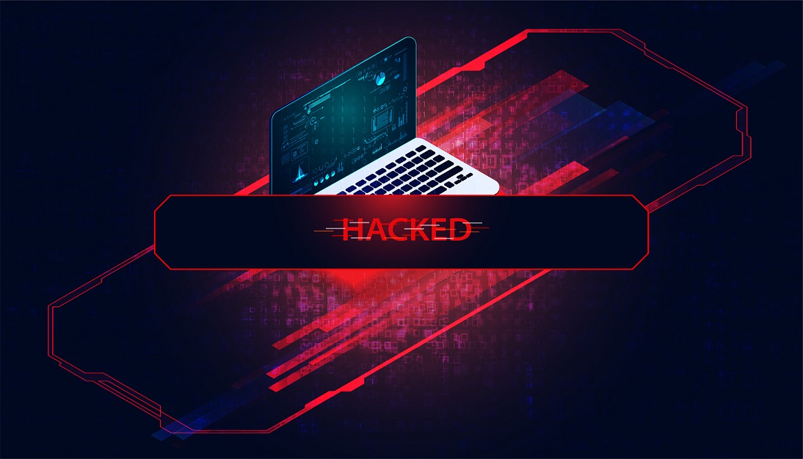 Laptop computer on red background with "Hacked" written in front