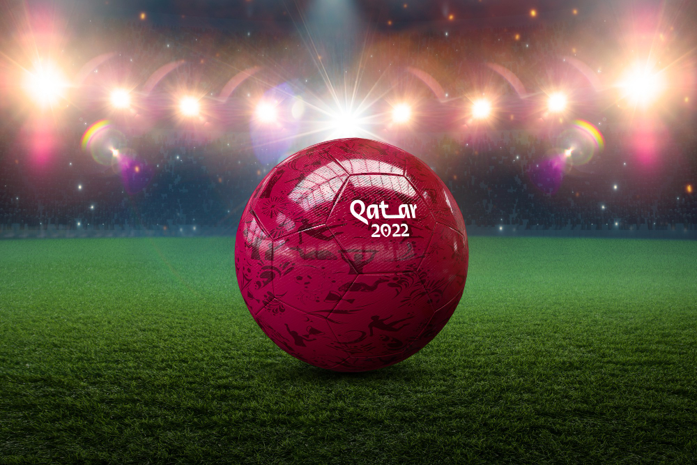 Red football with Qatar 2022 written on it