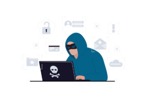 A hacker wearing a mask using a laptop.