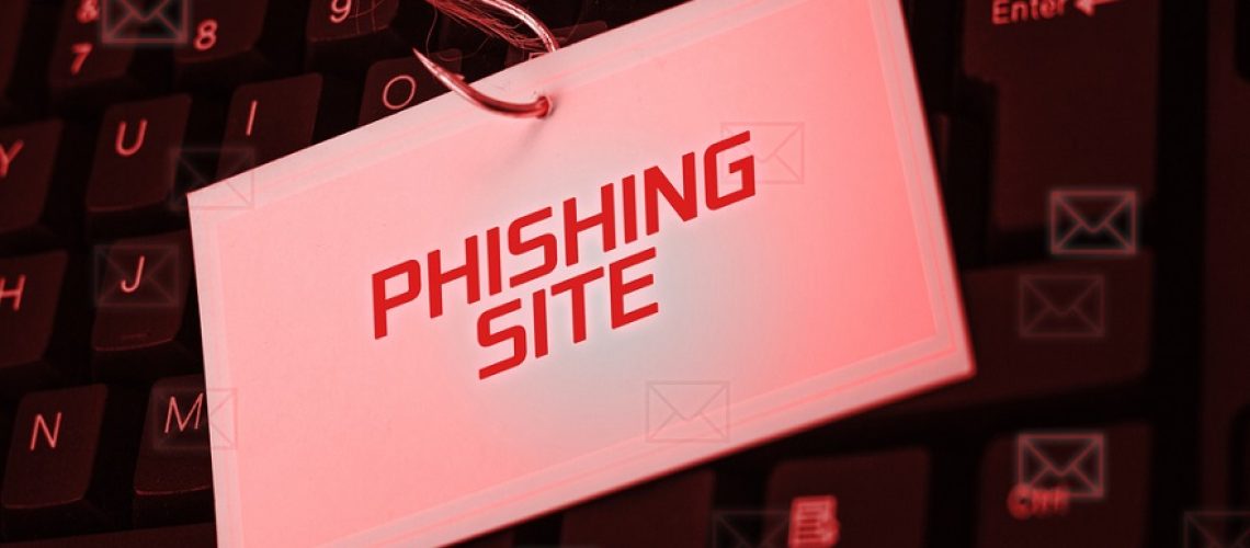 Keyboard with fishing hook through a label saying "Phishing Site"